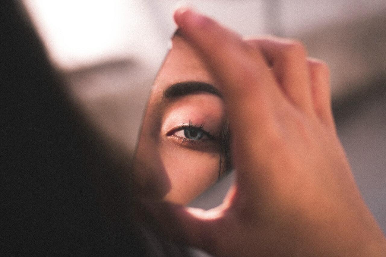 woman looking in the mirror